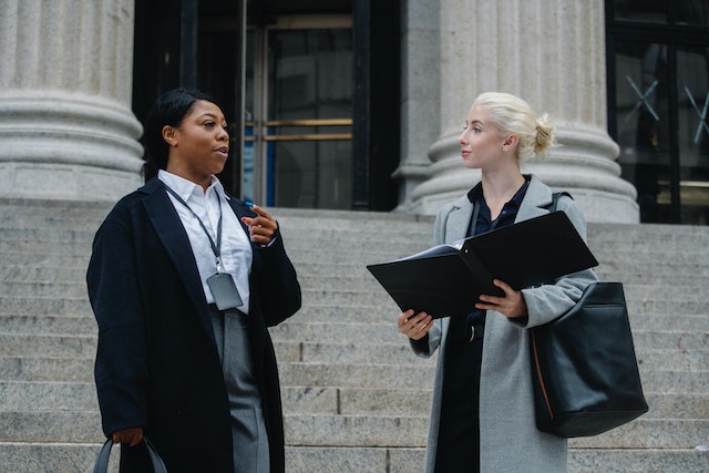 a%20lawyer%20and%20their%20client%20standing%20outside%20a%20court%20house%20looking%20over%20document a%20lawyer%20and%20their%20client%20standing%20outside%20a%20court%20house%20looking%20over%20document